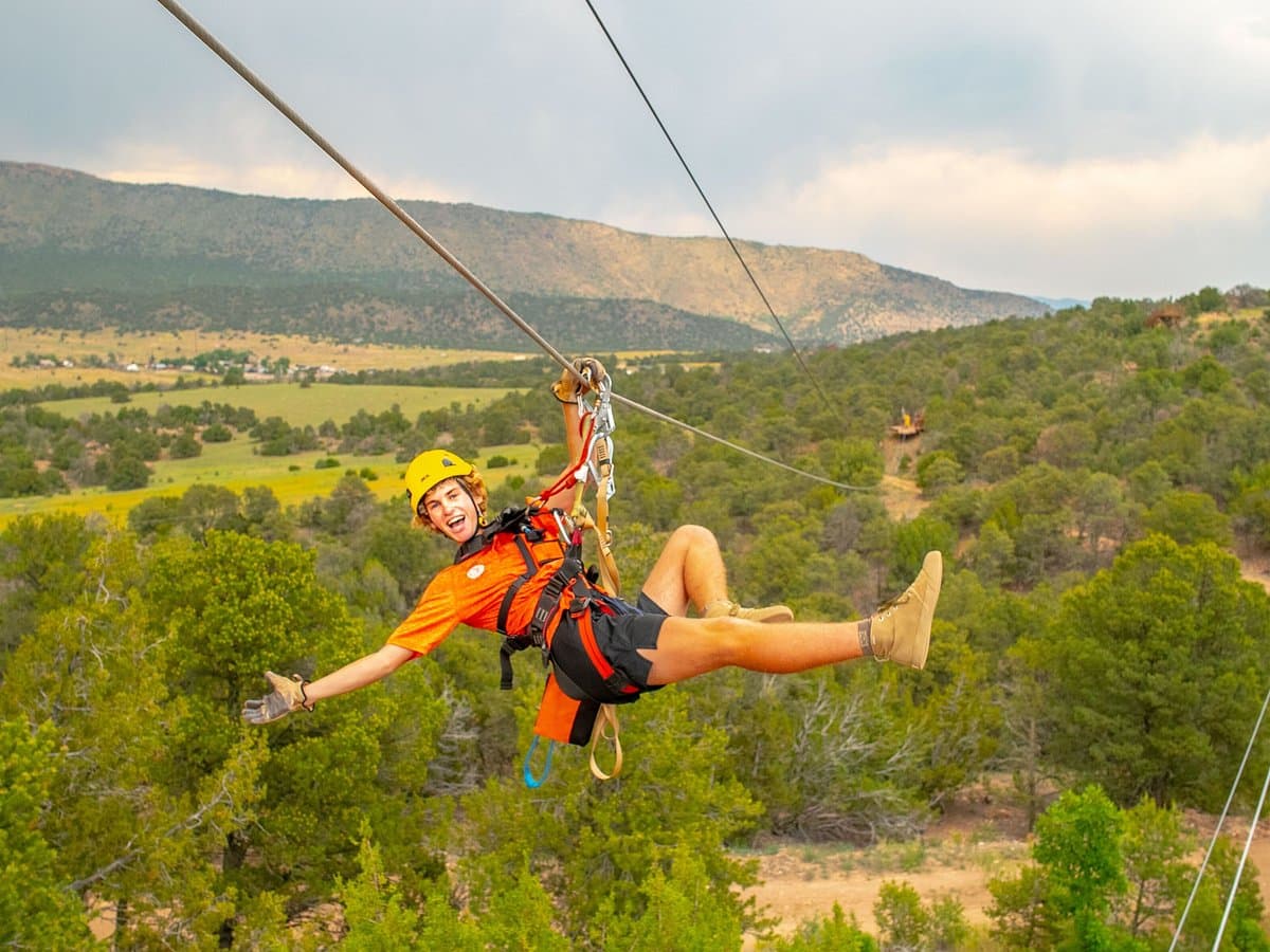 Zipline rider soaring over the canyon